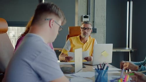 Professionals Meeting Around Conference Table in Modern Office