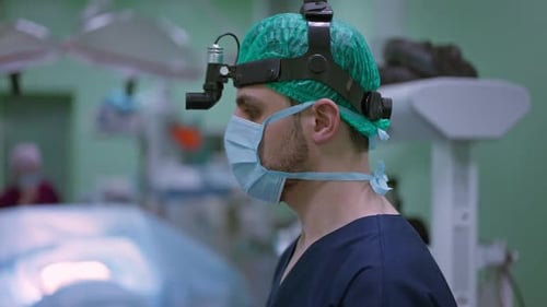 Side View Surgeon in Uniform Standing in Operating Room Talking in Slow Motion