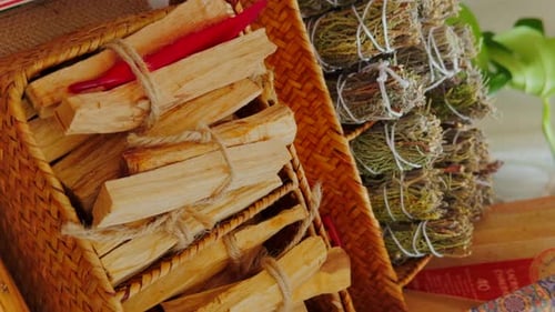 Palo santo sticks and incense sticks stacked in an outdoor market. Close up. Vertical video.