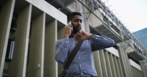 Young Adult Man Talking on Phone in City