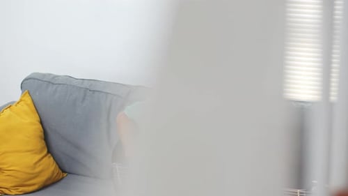 Young Adult Practicing Bass Guitar at Home