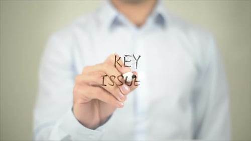 Key Issues Man Writing on Transparent Screen