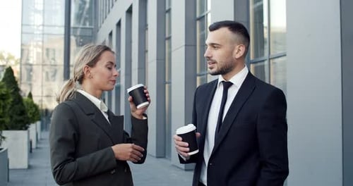 Good Looking Young Male and Female Business Colleagues Standing at the Street Near the Big Office