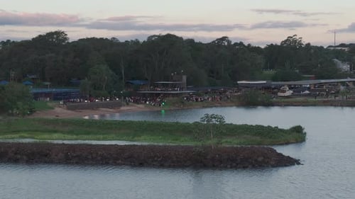 People having a party outdoors on the coastline. Aerial view.