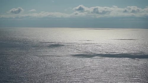 Timelapse Fluffy Cumulus Clouds Moving in Bright Sunset Sky Over Calm Sea Abstract Aerial Nature