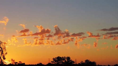 Vibrant Sunset Time-Lapse over a Silhouette Horizon