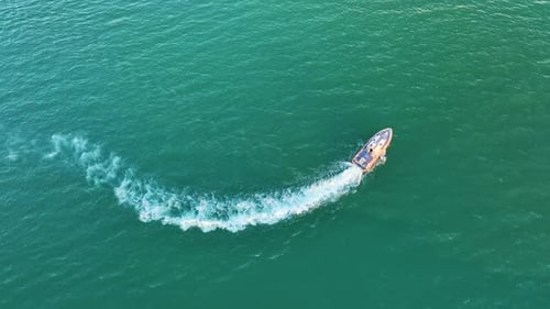 Aerial View of White Yacht Swimming on Sea Waves with Ripple Surface