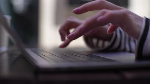 Hands Typing on Laptop Keyboard, Close Up