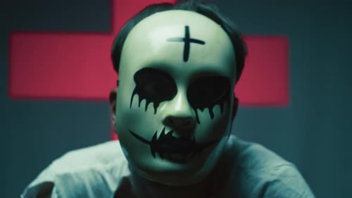 Man in Mask with Cross on Forehead