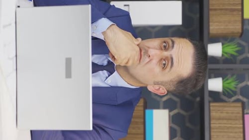 Man in Suit at Desk Using Laptop
