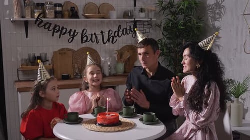 Family Celebrating Birthday at Home with Cake