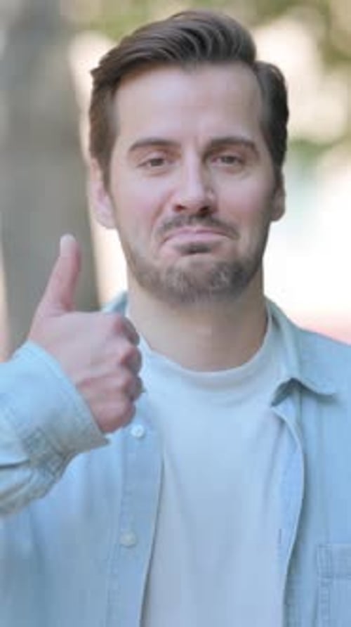 Man Gives Thumbs Up Approval Outdoors Portrait