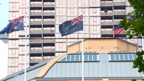 Australian National Flags Waving in Front of Building