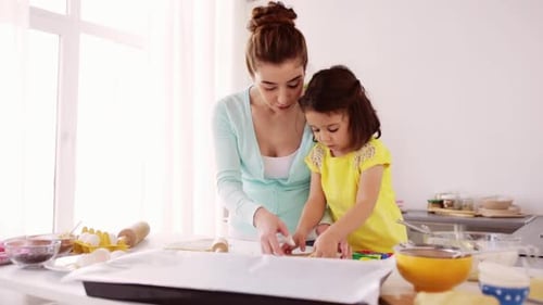Woman and Child Baking Together in Bright Kitchen