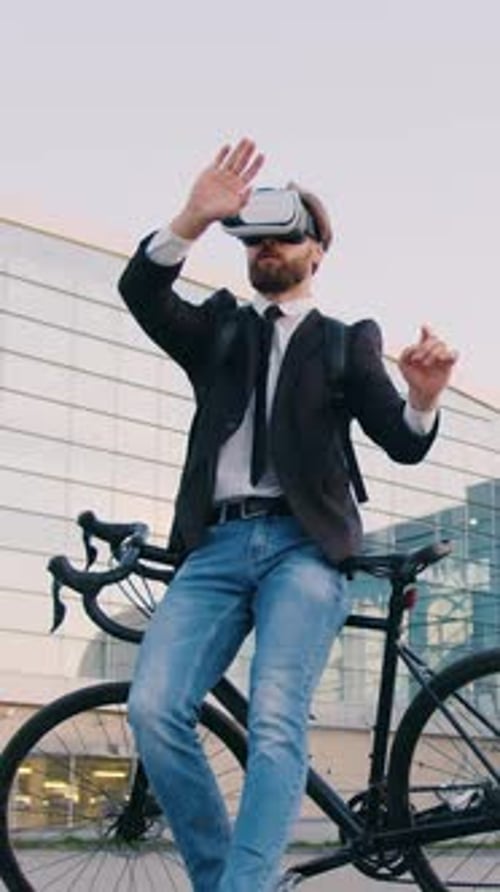 Close Up of Likable Concentrated Successful Young Man Office Manager Which Leaning on Own Bike Near