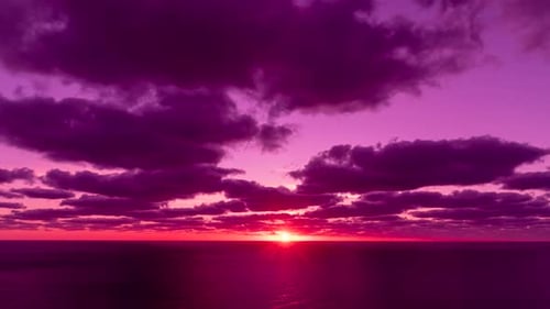 Timelapse Dramatic Sunset with Fluffy Clouds Moving in Sky Over Sea