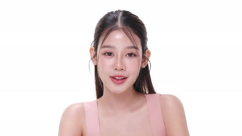 Close up portrait beautiful young Asian woman with healthy facial skin over white background.