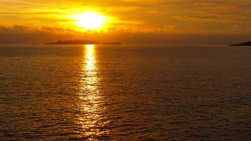 Golden Sun Setting Over the Calm Sea Horizon