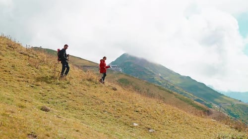 Couple Hiking on a Mountain Slope