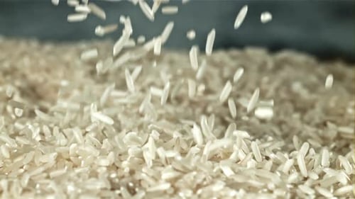 Close Up of Rice Falling Into a Pile