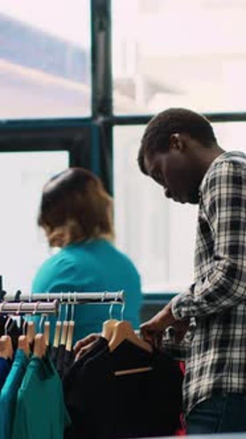 Young Man Shopping for Clothes at Retail Store