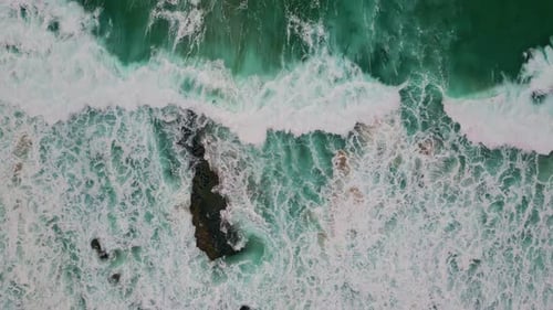 Top View Turbulent Waves Swelling on Beach with Bubbling White Foam Sea Forming