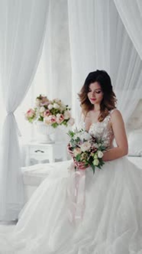 Elegant Bride in White Gown Holds Flower Bouquet