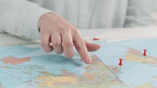 Hand Tracing Travel Route on World Map
