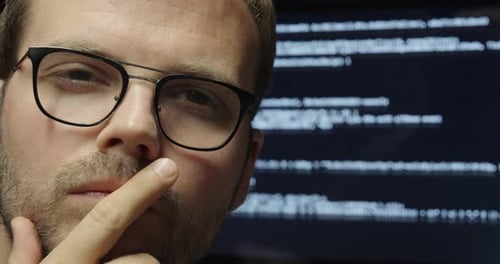 A man thinking about AI and developing an idea, with a blurred AI chatbot working in the background