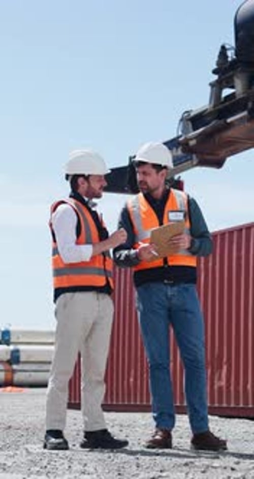 Shipping yard, talking and men with clipboard for distribution, supply chain and inventory list