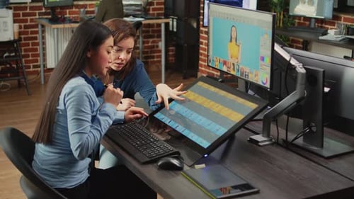 Women Collaborating on Video Editing in Modern Office