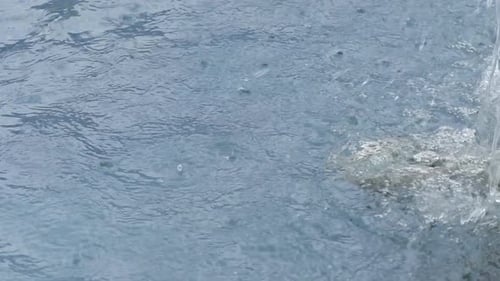 Clear fresh water in urban fountain, slow motion
