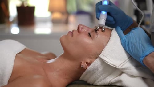 Woman Receiving Facial Treatment at Beauty Spa