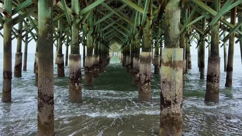 Ocean Waves crashing under the Apache Pier in Myrtle Beach South Carolina.
