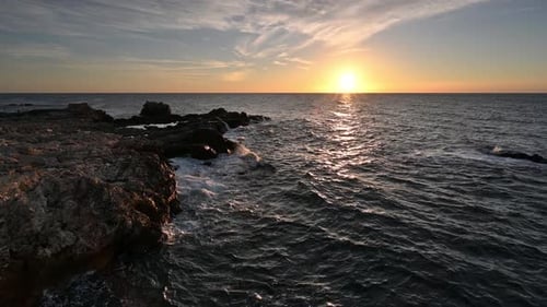 Rising sun above beautiful rocky coast