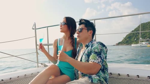Couple on Catamaran Drinks Blue Cocktails in Tropical Paradise