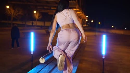 Trap Artist Dancing on a Park Table at Night