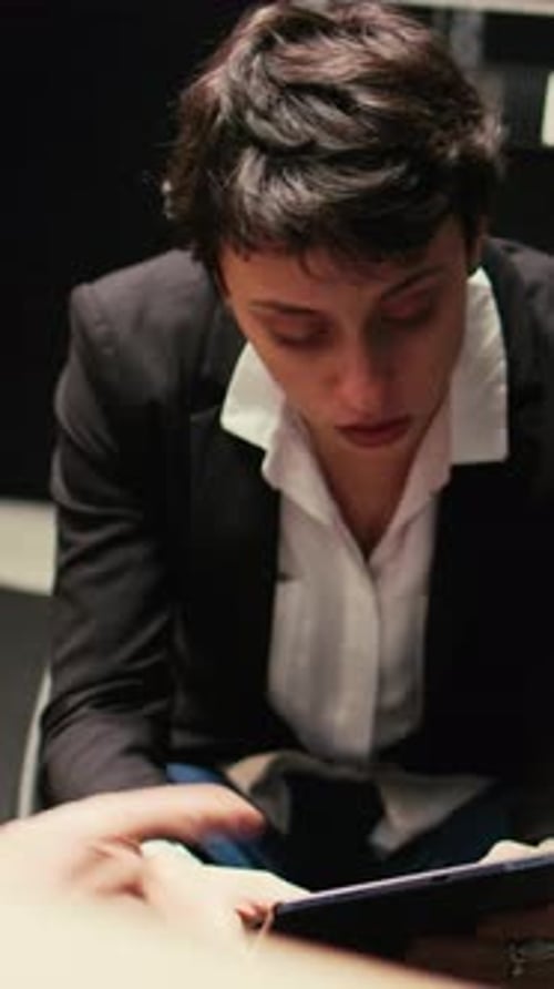 Woman Working With Tablet in Dimly Lit Studio