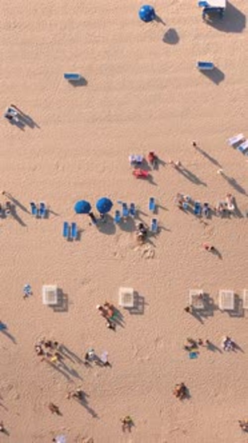Stunning Aerial View of Miami Beach Featuring Sunbathers Relaxing Under Colorful Umbrellas