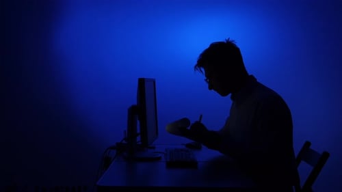 Person Working Late Night in Digital Dark Office