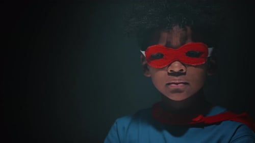 Studio Portrait of Little African American Kid in Superhero Suit