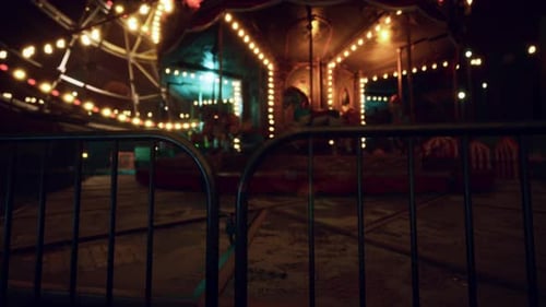 Deserted Amusement Park with Carnival Rides Illuminated By Colorful Lights