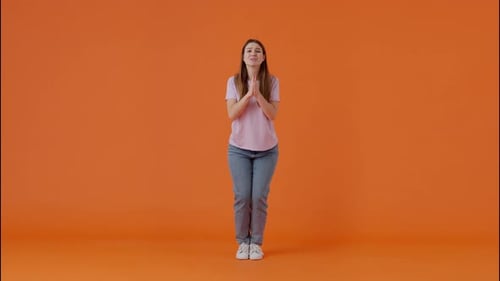 Woman Begging in Praying Pose and Jumping Joyfully in Studio