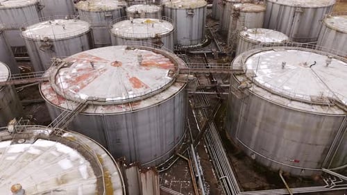 Massive Fuel Storage Facility - Overhead Drone of Aging Tanks - Overcast Day