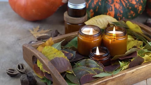 Candles and Pumpkins on Wooden Tray with Autumn Leaves