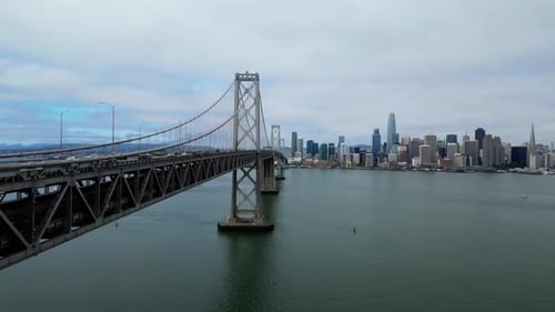 Drone Flying Forward Over Oakland Bay Bridge Toward San Francisco Skyline