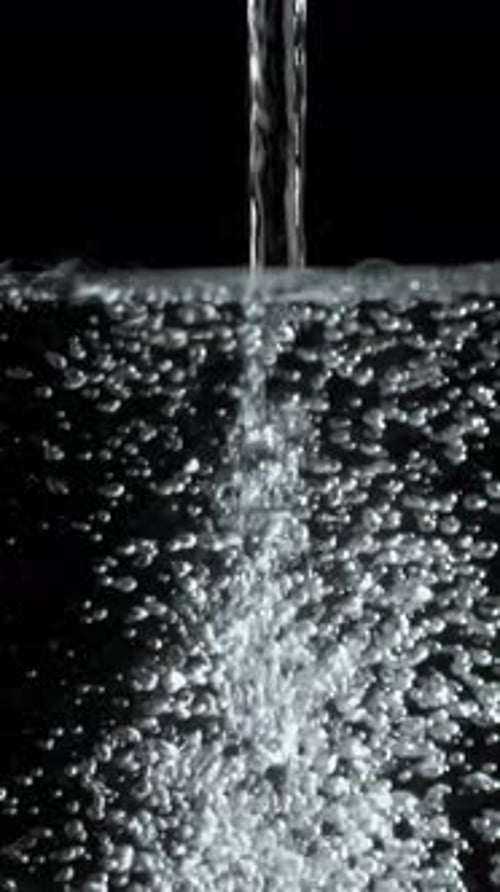 Clear Water Pouring Creates Bubbles