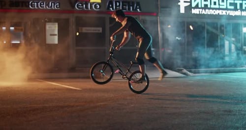 BMX Bike Stunt at Night in Urban Setting