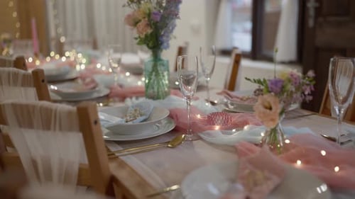 Close-up shot of a decorated and prepared wedding reception table. Luxury tableware, glasses