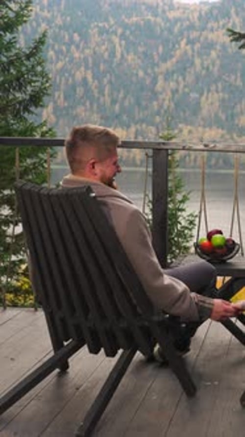 Couple Smiles with Hands Entwined on Terrace